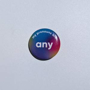 Button badge with 'my pronouns are any' text on a plain background